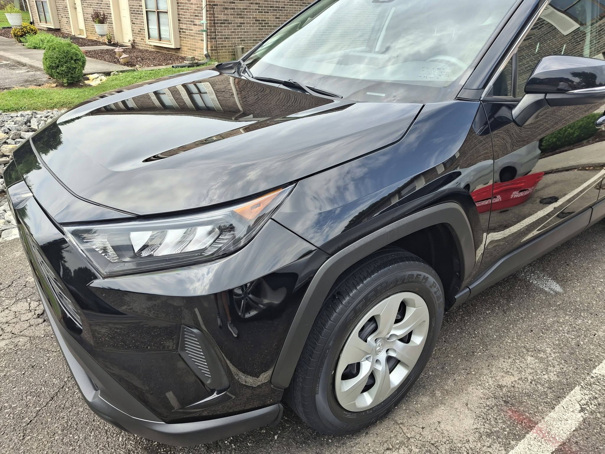 Detailed black Toyota RAV4 front end with deep gloss